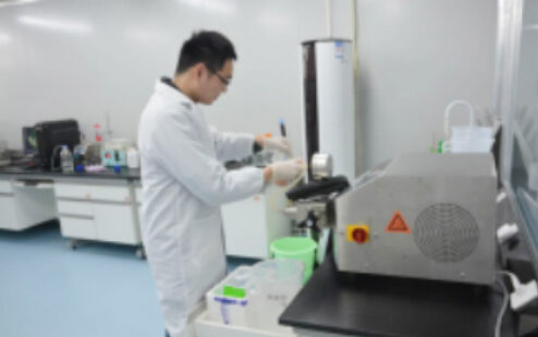 Technician operating laboratory equipment
